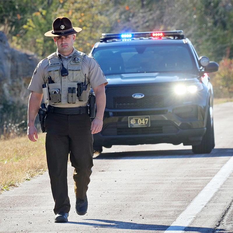 jefferson county deputy walking on road with car in background